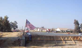 Flag flying above construction