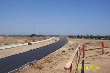 Paved road near wooden scaffolding