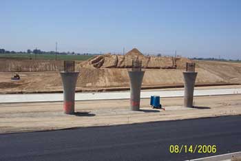 Paved road near bridge pylons