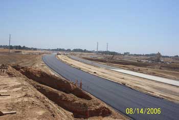 Paved road near dug piles