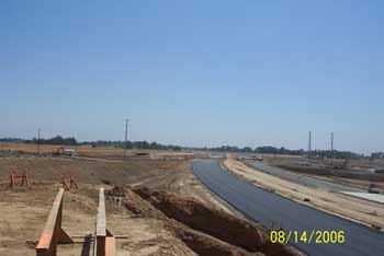 Paved road near wooden frameworks