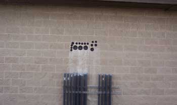 Markings on a wall above pipes