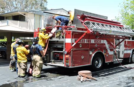 Firefighters working with a fire engine