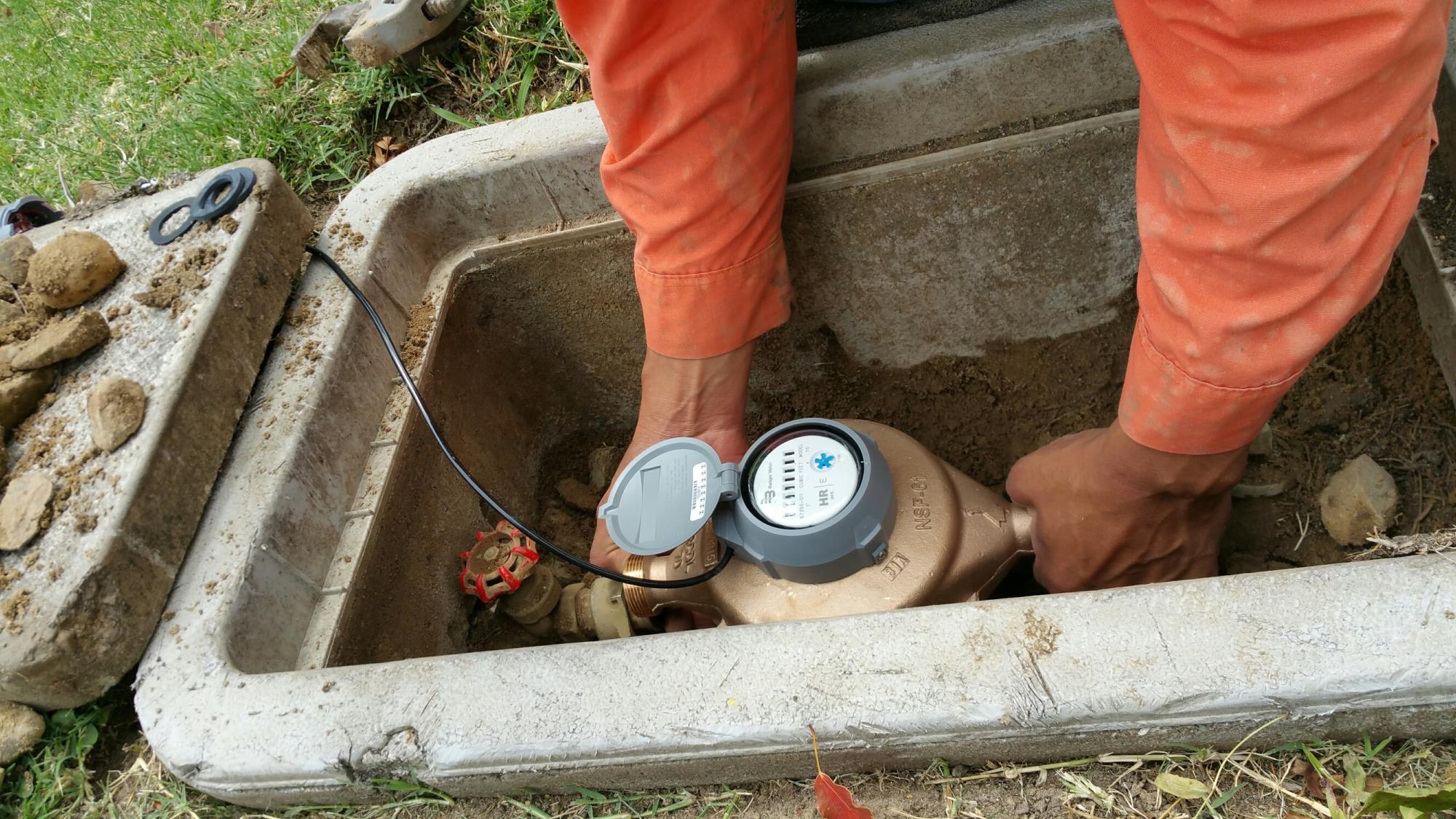 Water meter being inspected