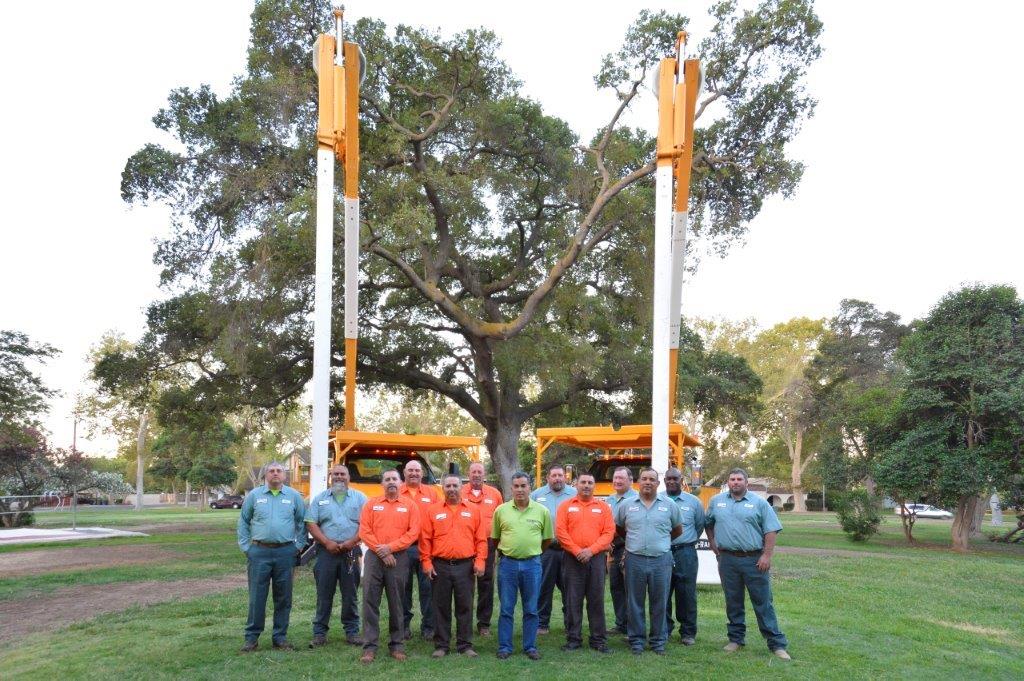 Parks department in front of maintenance vehiclees